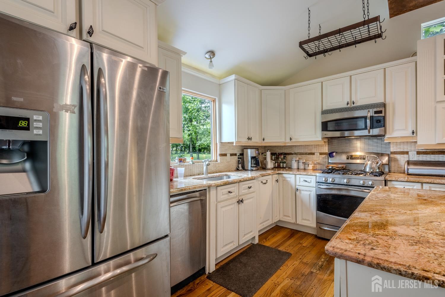 170 Jordan Road Colonia, NJ 07067 - Photo 9 of 36 a kitchen with stainless steel appliances granite countertop a refrigerator a sink dishwasher a stove top oven a refrigerator and white cabinets