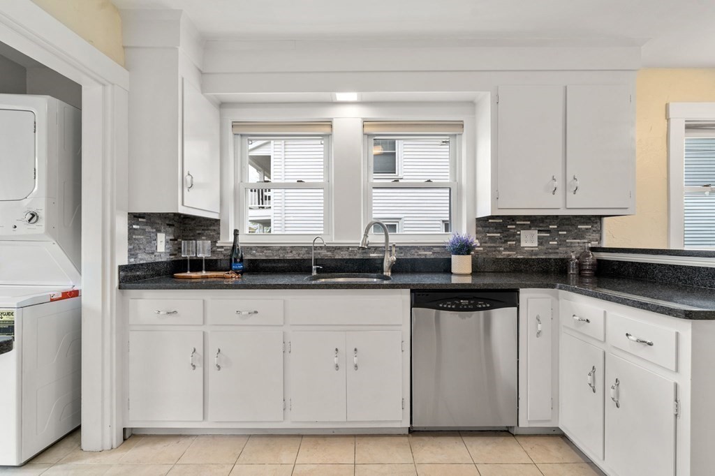 23 Fuller Road, Unit 23 Watertown, MA 02472 - Photo 13 of 31 a kitchen with granite countertop white cabinets and a sink