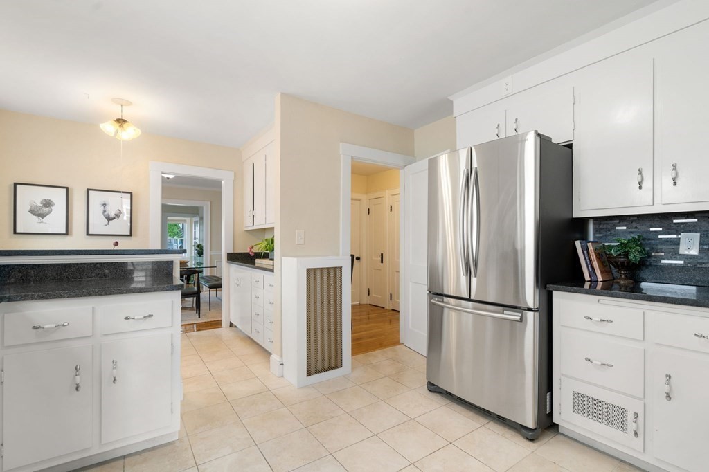 23 Fuller Road, Unit 23 Watertown, MA 02472 - Photo 14 of 31 a kitchen with white cabinets and refrigerator