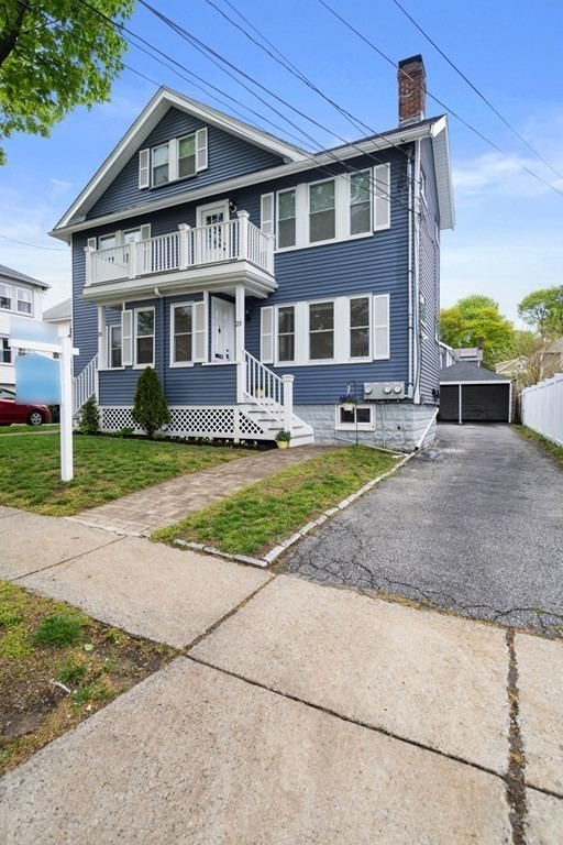 23 Fuller Road, Unit 23 Watertown, MA 02472 - Photo 2 of 31 a view of a big house with a yard and plants