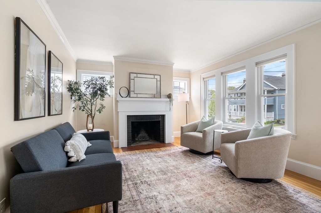 23 Fuller Road, Unit 23 Watertown, MA 02472 - Photo 6 of 31 a living room with furniture and a fireplace