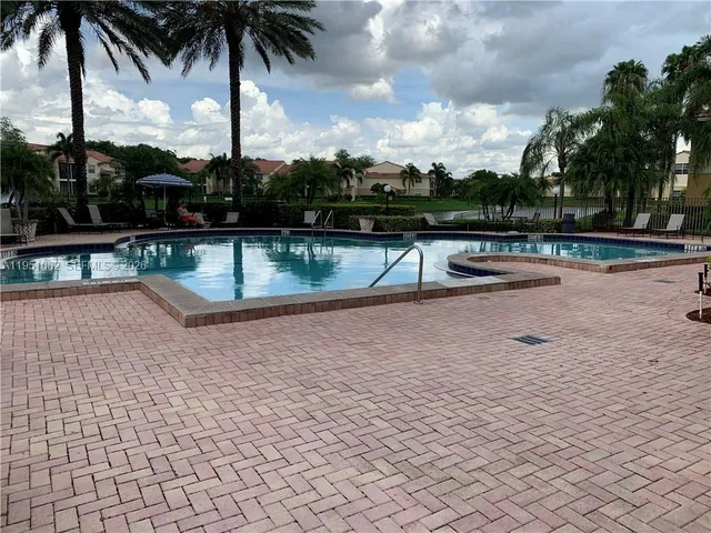 a view of swimming pool with a lounge chair