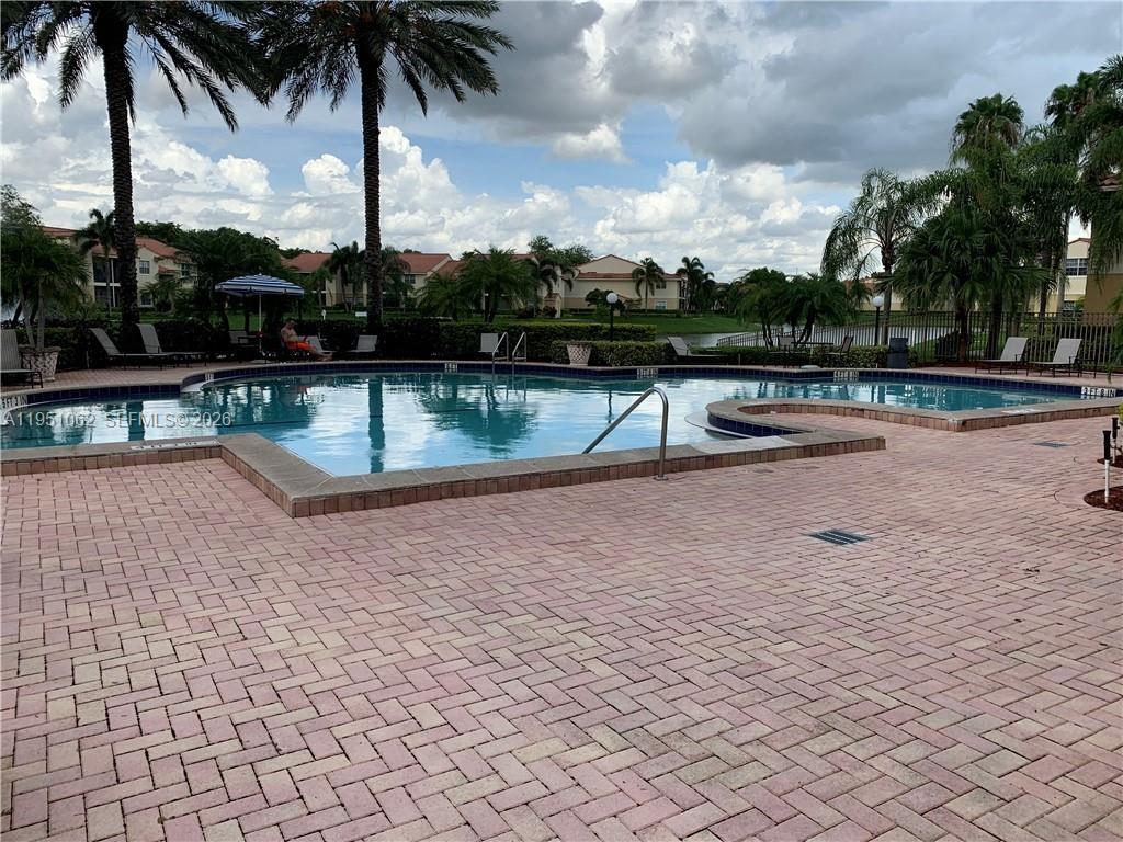 1235 Southwest 46th Avenue, Unit 711 Pompano Beach, FL 33069 - Photo 12 of 43 a view of swimming pool with a lounge chair