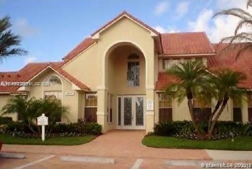 1235 Southwest 46th Avenue, Unit 711 Pompano Beach, FL 33069 - Photo 16 of 43 a front view of a house with a yard