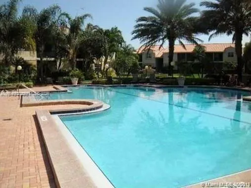 a view of a swimming pool with a lawn chairs