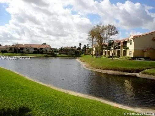 a view of a lake with houses in the back