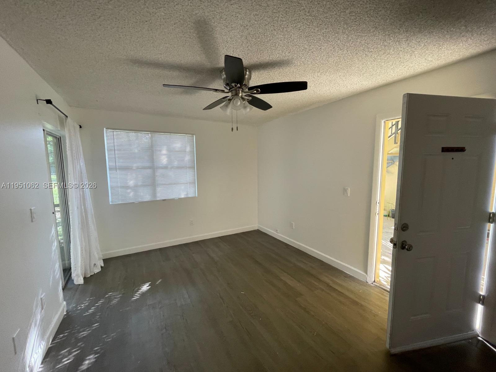 1235 Southwest 46th Avenue, Unit 711 Pompano Beach, FL 33069 - Photo 31 of 43 an empty room with windows and fan