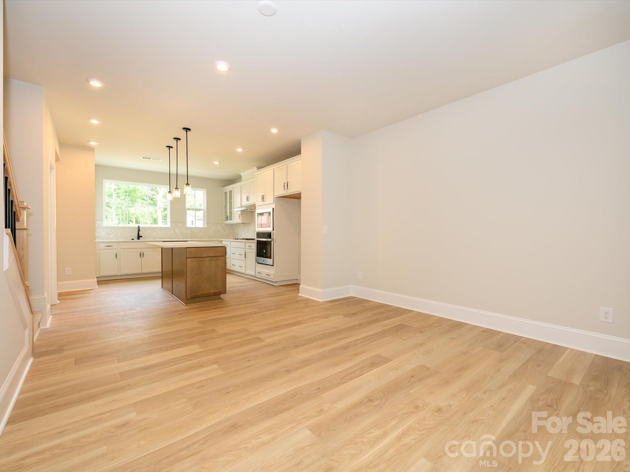 412 Old Town Vlg Road Waxhaw, NC 28173 - Photo 12 of 29 a view of kitchen and hall with wooden floor