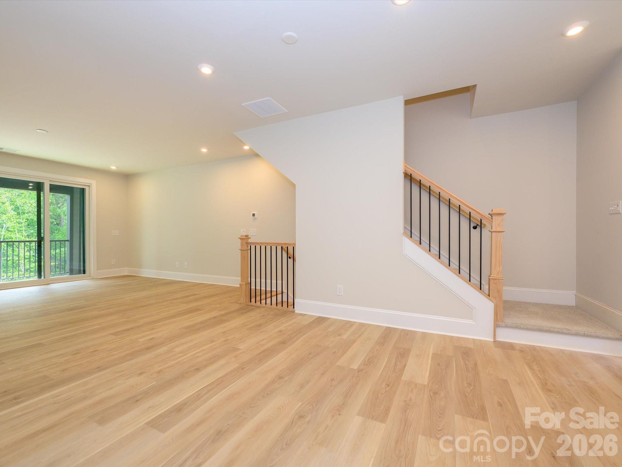 412 Old Town Vlg Road Waxhaw, NC 28173 - Photo 13 of 29 a view of an empty room with wooden floor and a window