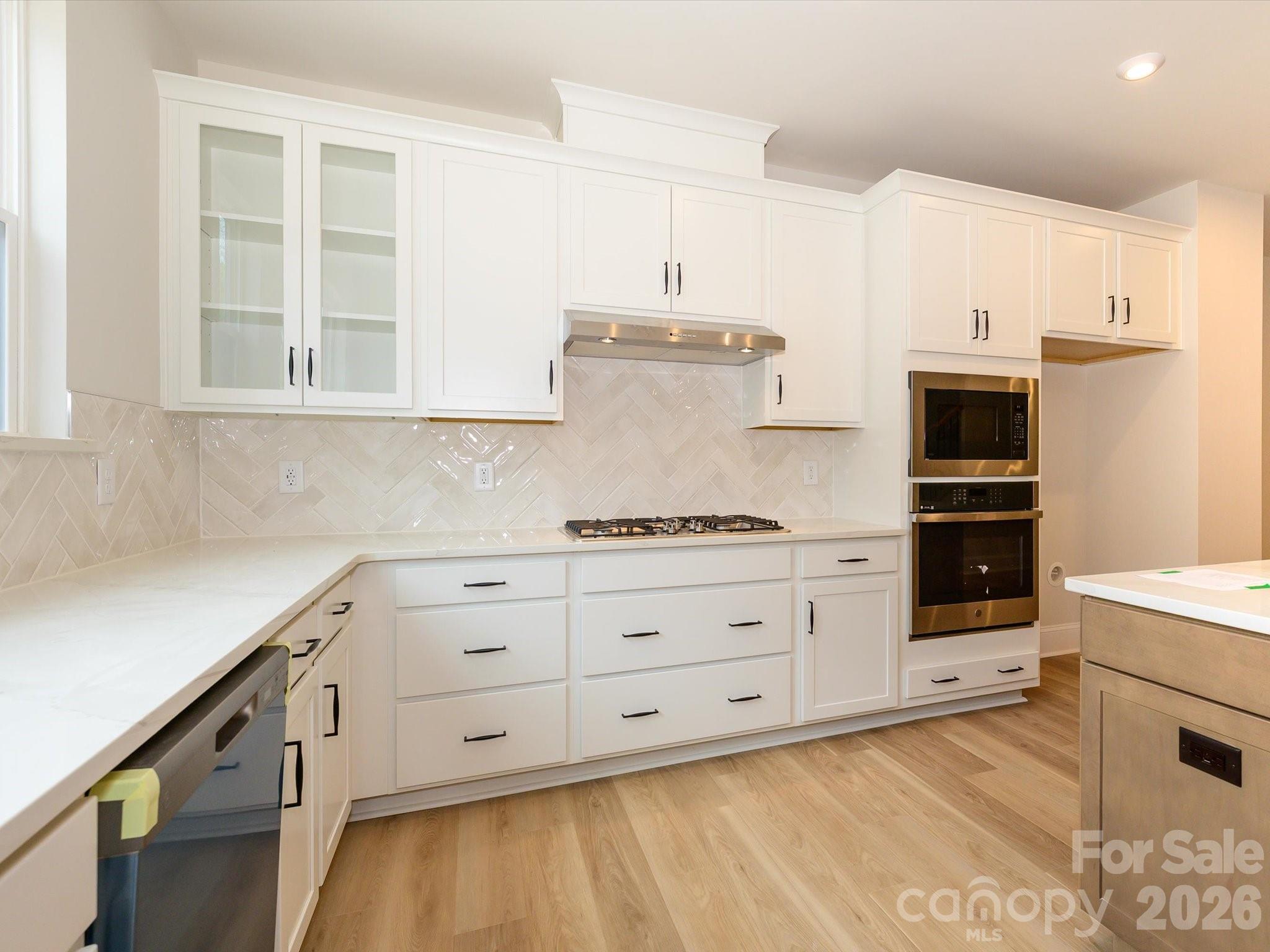 412 Old Town Vlg Road Waxhaw, NC 28173 - Photo 17 of 29 a kitchen with granite countertop white cabinets and stainless steel appliances