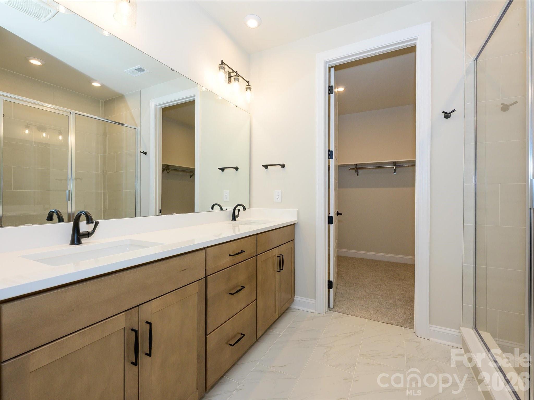 412 Old Town Vlg Road Waxhaw, NC 28173 - Photo 25 of 29 a bathroom with a double vanity sink mirror and shower