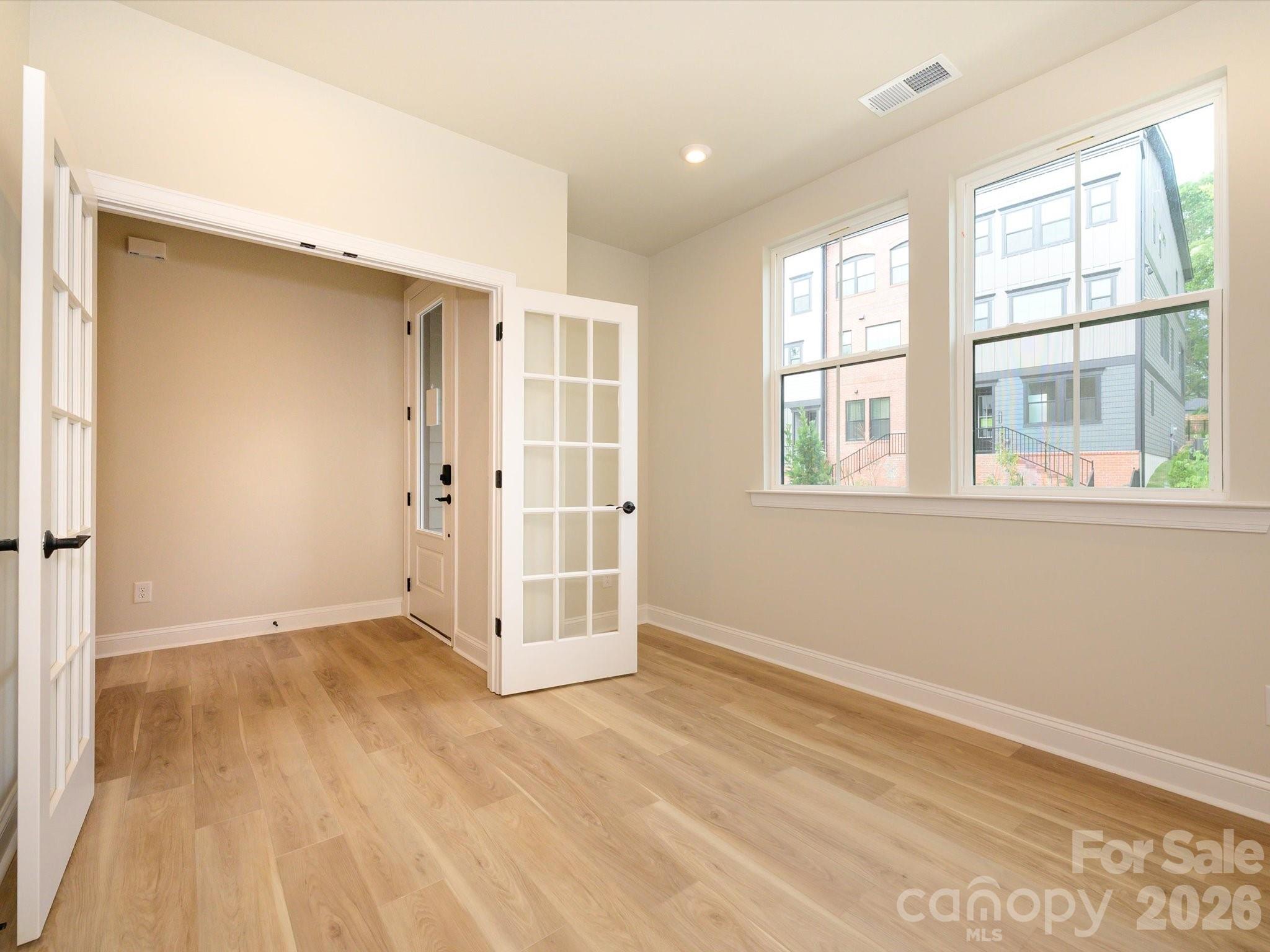 412 Old Town Vlg Road Waxhaw, NC 28173 - Photo 5 of 29 an empty room with wooden floor and windows