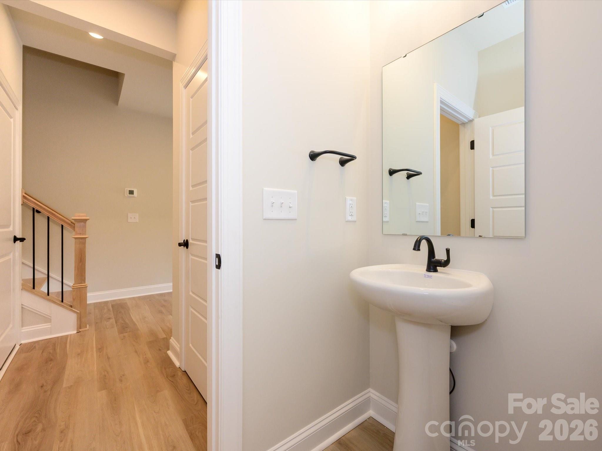 412 Old Town Vlg Road Waxhaw, NC 28173 - Photo 6 of 29 a bathroom with a sink a mirror and shower