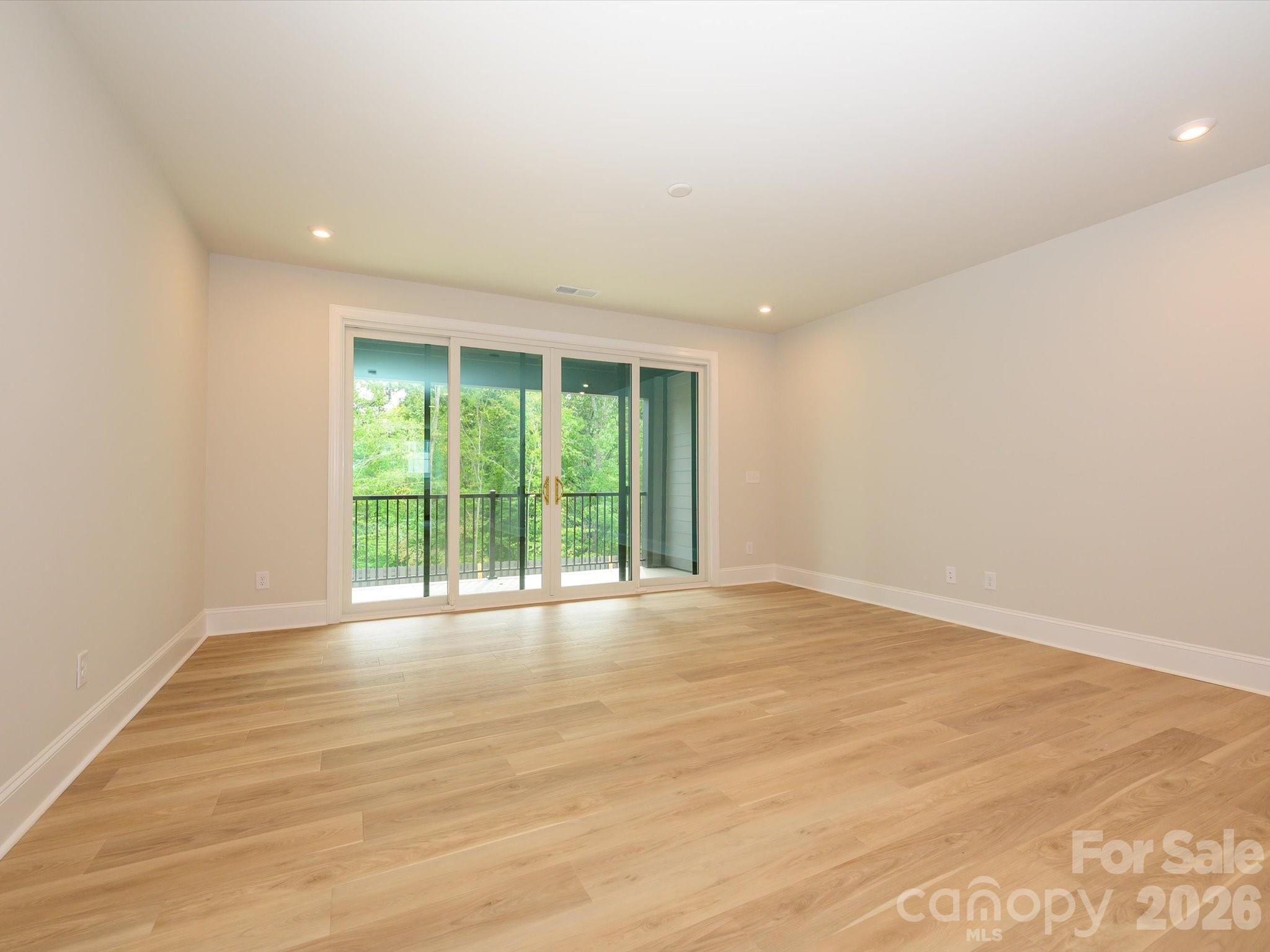 412 Old Town Vlg Road Waxhaw, NC 28173 - Photo 7 of 29 a view of an empty room with wooden floor and a window