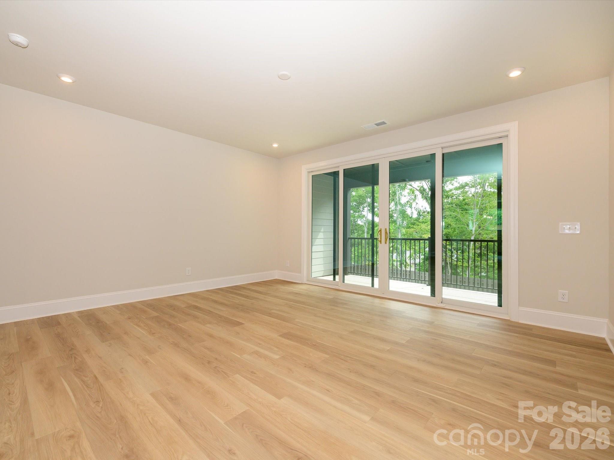 412 Old Town Vlg Road Waxhaw, NC 28173 - Photo 8 of 29 a view of an empty room with wooden floor and a window