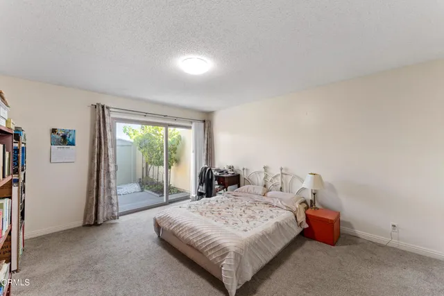 a bedroom with a bed and large window