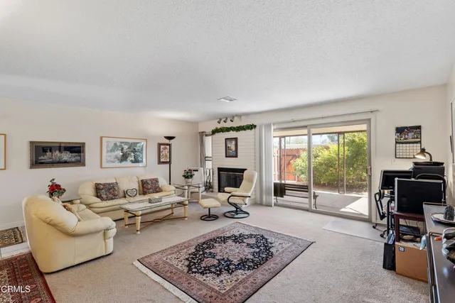 a living room with furniture flat screen tv and a fireplace