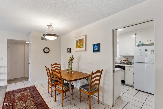 a view of a dining room with furniture and a chandelier