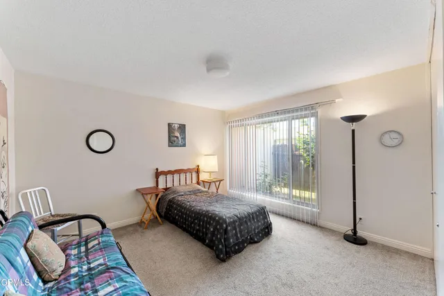 a spacious bedroom with a bed and window