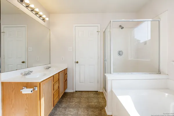 a bathroom with a sink a mirror and a shower
