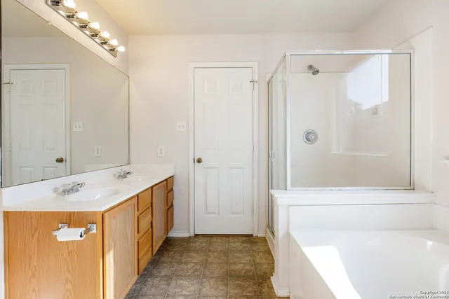 a bathroom with a sink a mirror and a shower