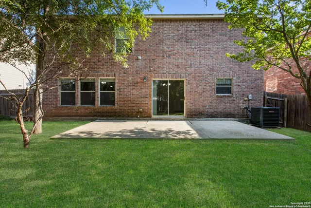 a front view of a house with a yard and trees
