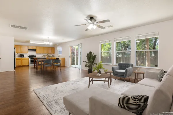 a living room with furniture and wooden floor