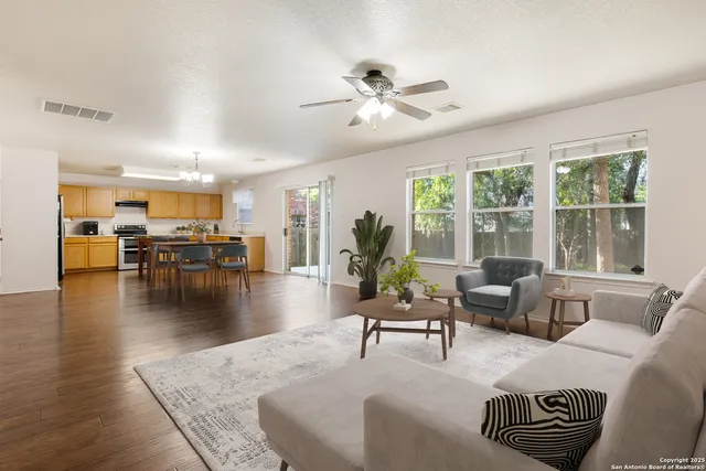 a living room with furniture and wooden floor