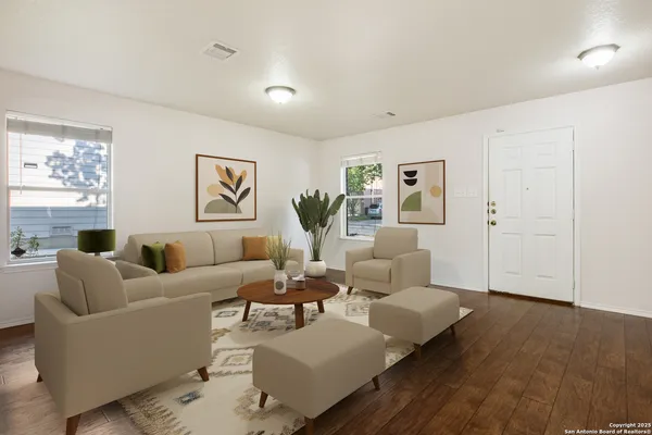 a living room with furniture and wooden floor