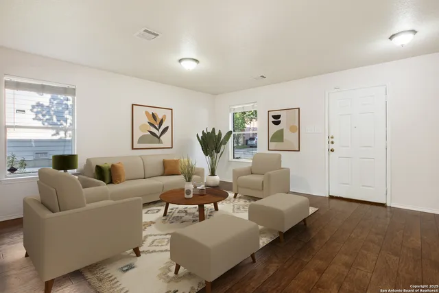 a living room with furniture and wooden floor