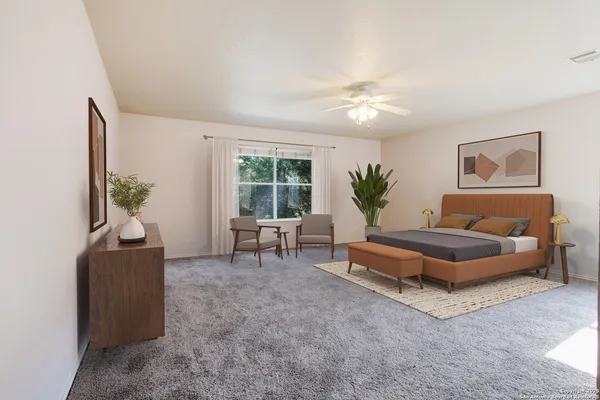 a living room with furniture and a potted plant