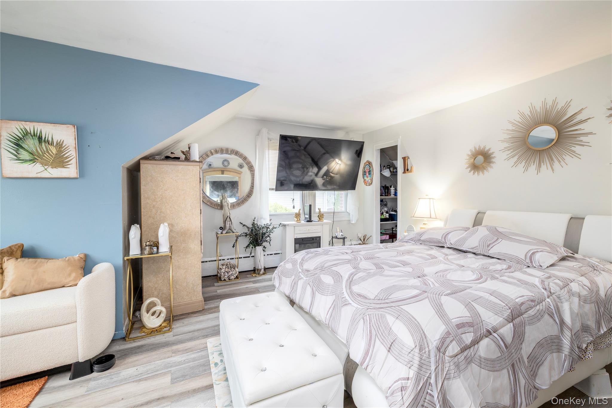 265 Beachview Street Copiague, NY 11726 - Photo 11 of 19 a spacious bedroom with a bed and a couch