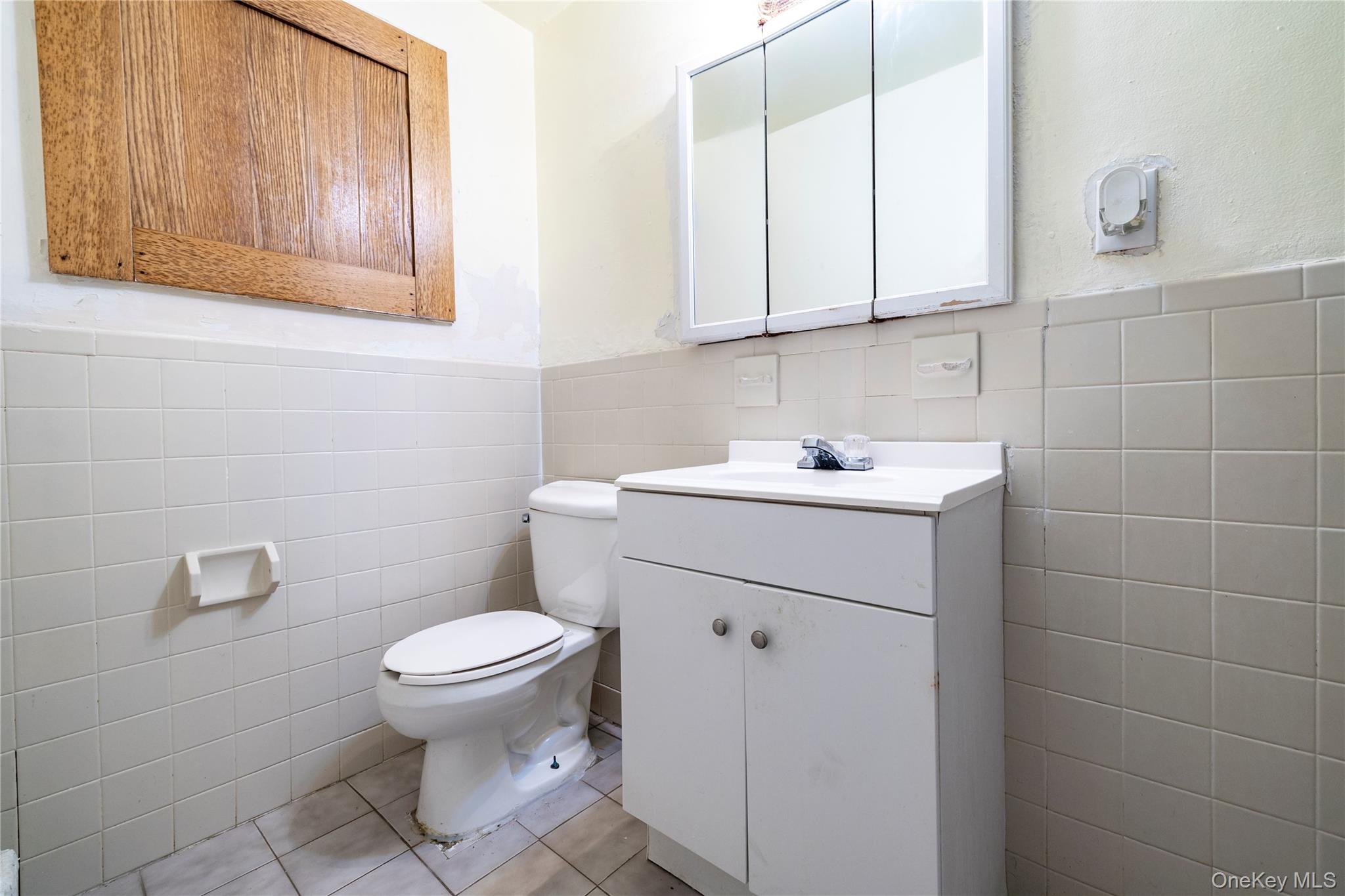 265 Beachview Street Copiague, NY 11726 - Photo 16 of 19 a bathroom with a sink toilet and vanity