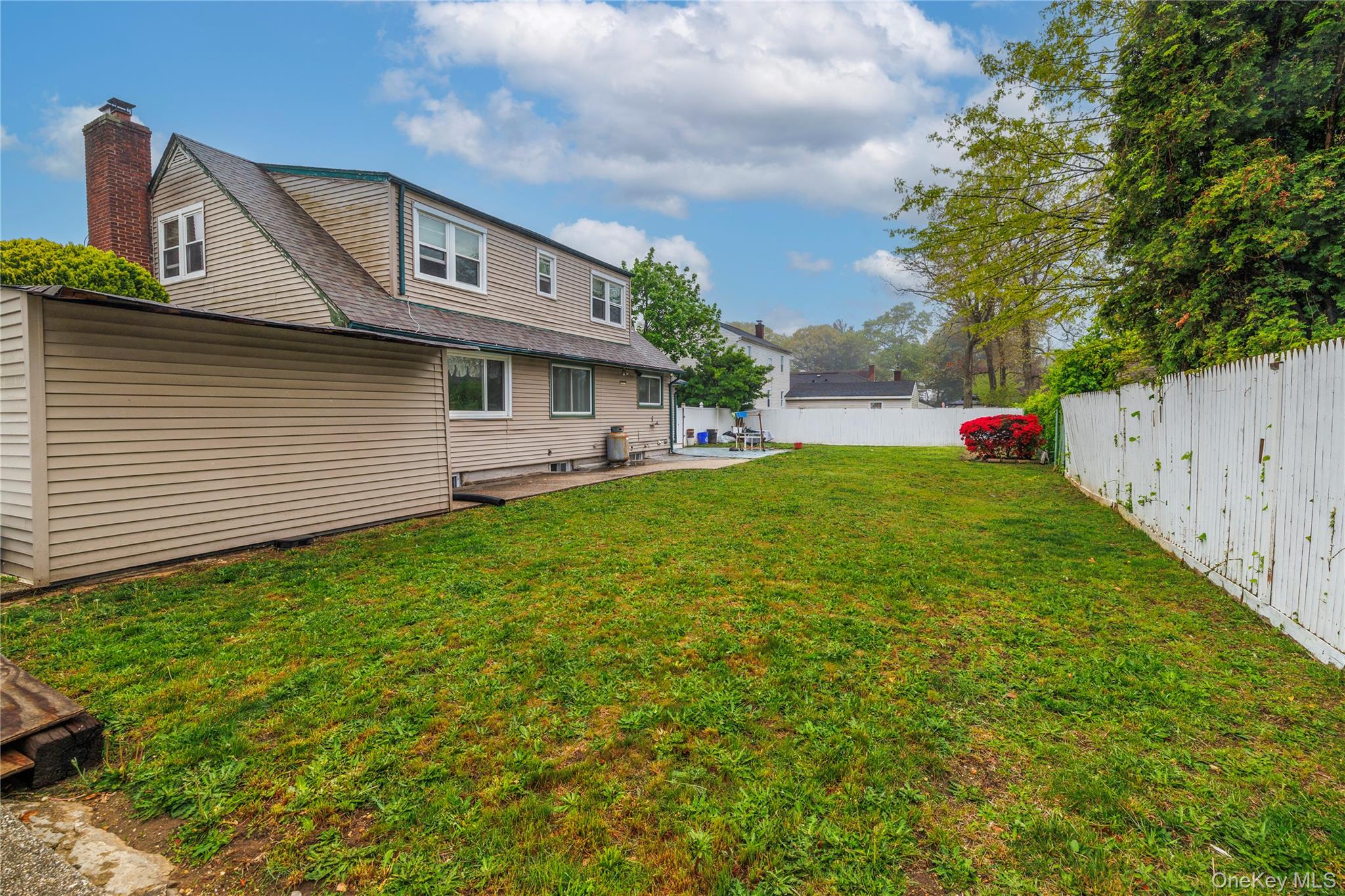 265 Beachview Street Copiague, NY 11726 - Photo 19 of 19 a front view of a house with a yard