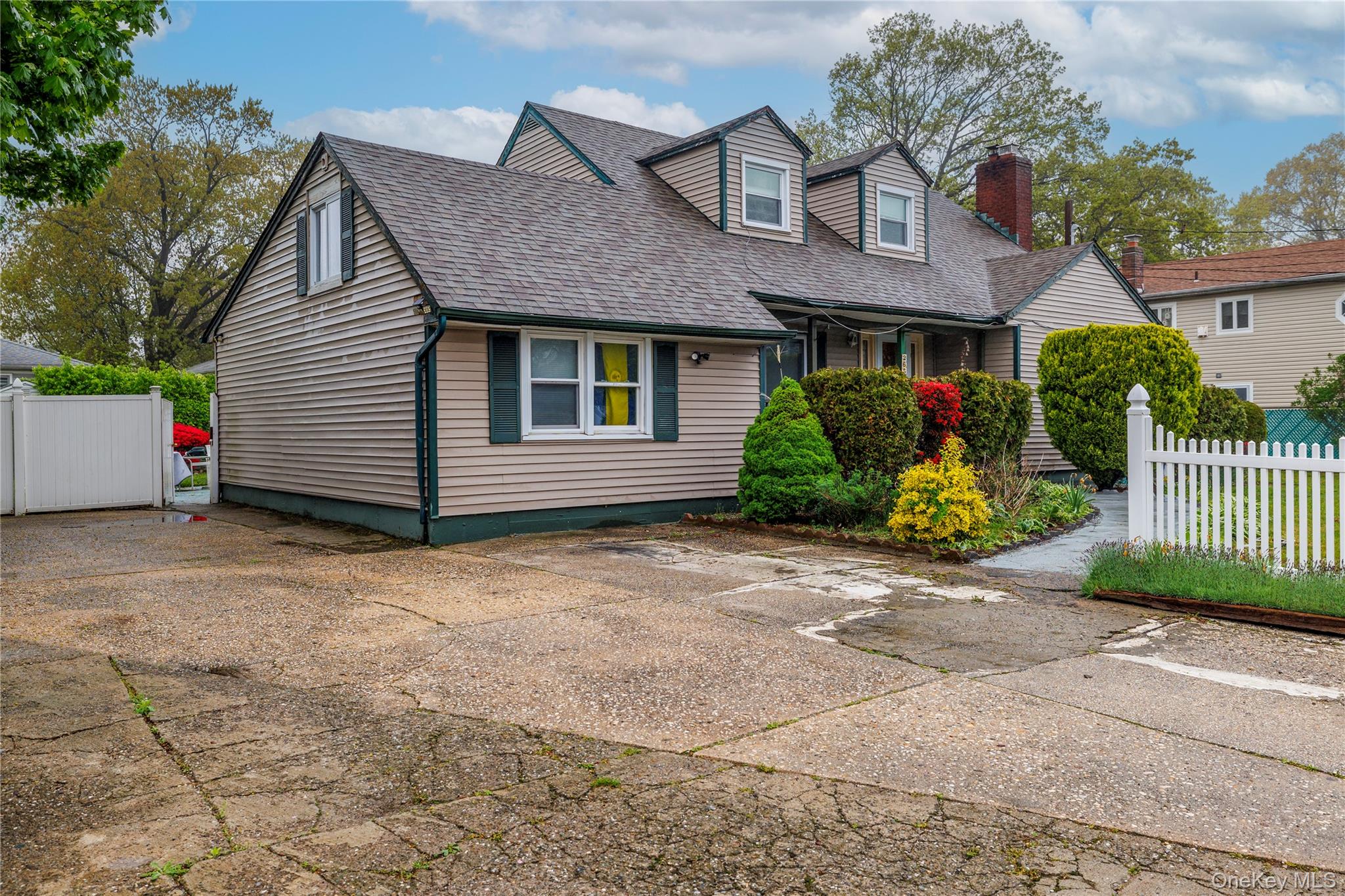 265 Beachview Street Copiague, NY 11726 - Photo 2 of 19 a front view of a house with a yard