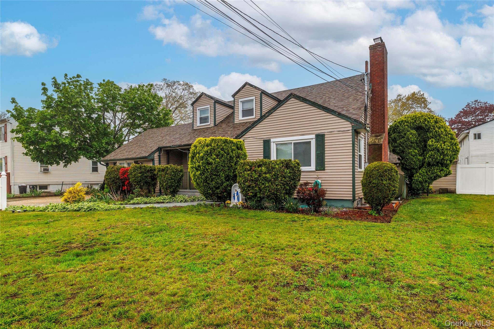 265 Beachview Street Copiague, NY 11726 - Photo 3 of 19 a view of a house with a big yard and potted plants