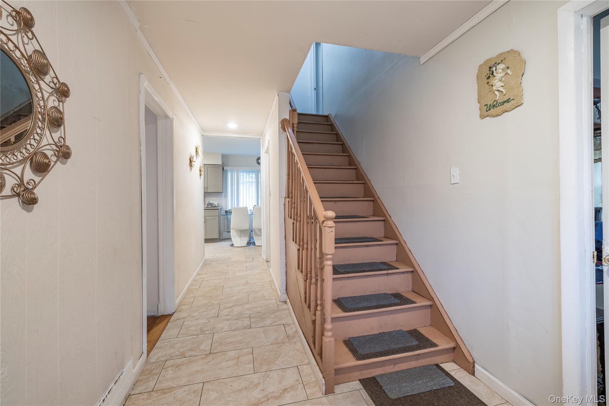 265 Beachview Street Copiague, NY 11726 - Photo 10 of 19 a view of a hallway with wooden floor and entryway