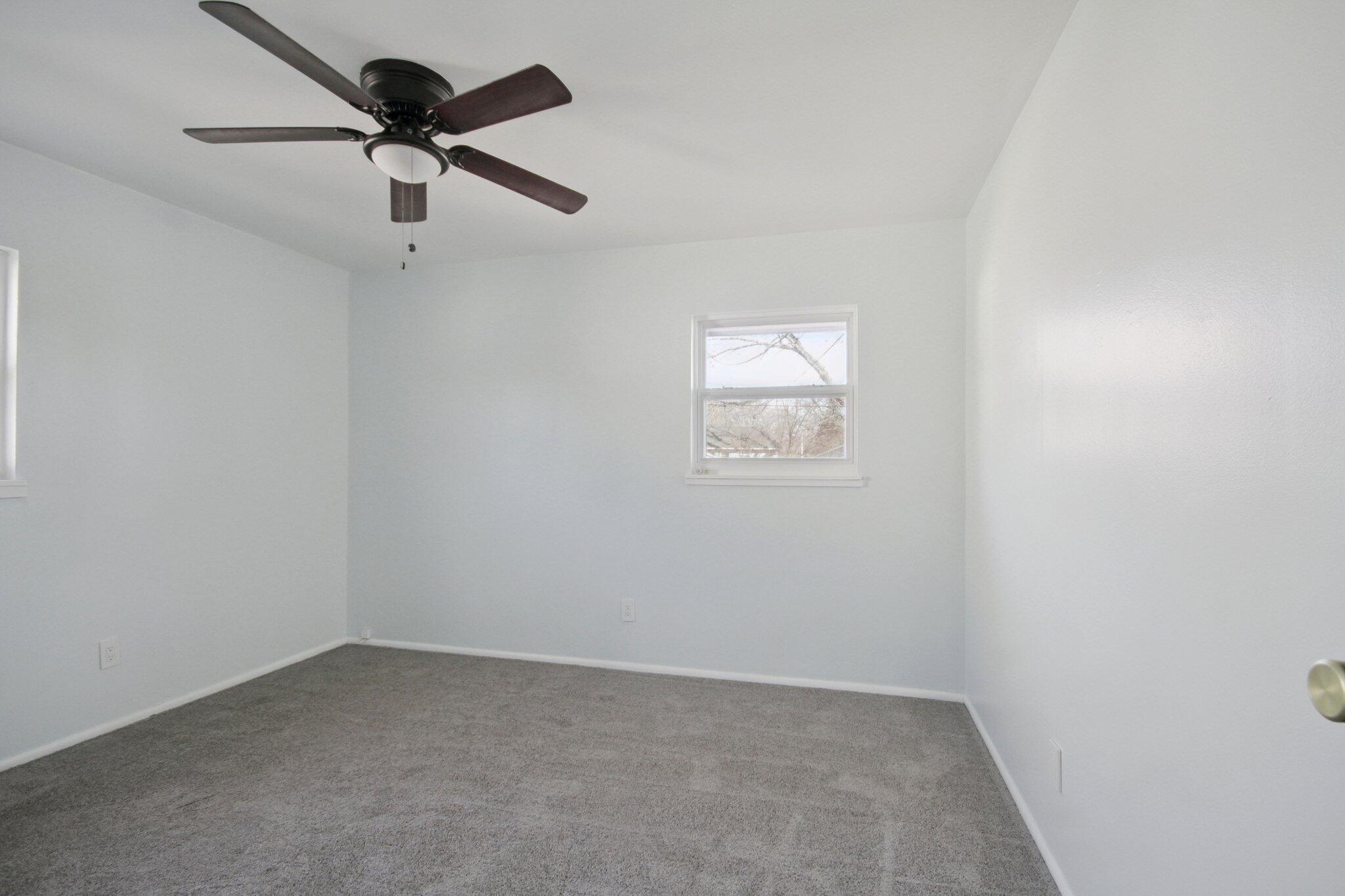 2355 McCool Road Portage, IN 46368 - Photo 11 of 19 an empty room with a window and a fan