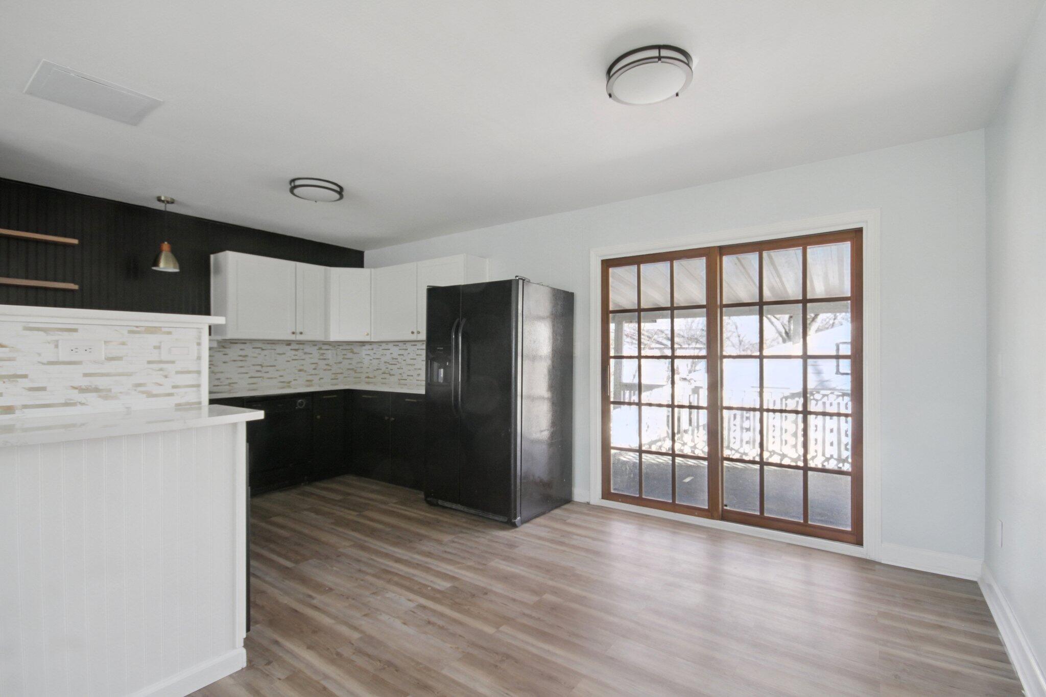2355 McCool Road Portage, IN 46368 - Photo 7 of 19 a view of kitchen and empty room with wooden floor