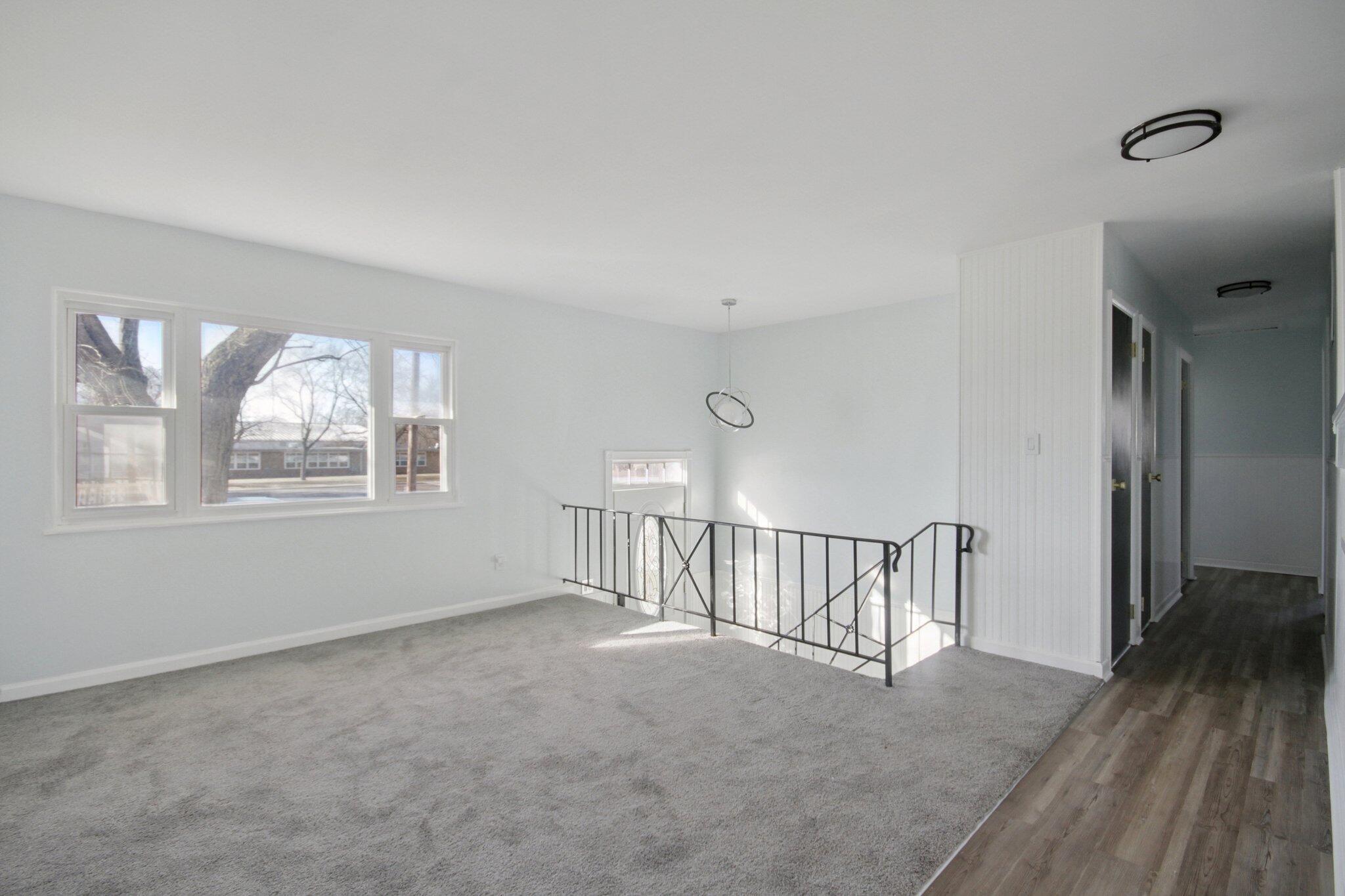 2355 McCool Road Portage, IN 46368 - Photo 9 of 19 a view of an empty room with wooden floor and a window