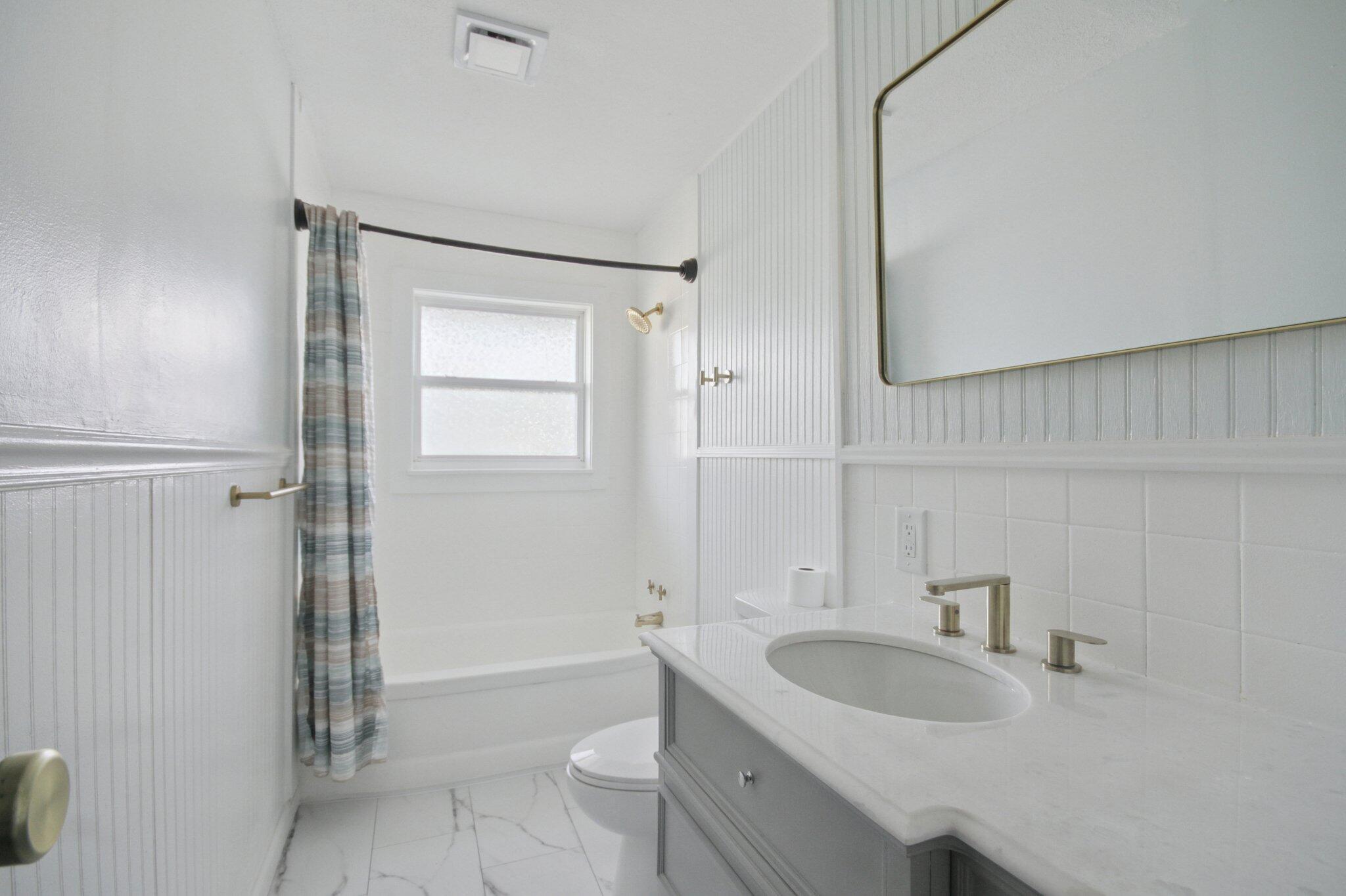 2355 McCool Road Portage, IN 46368 - Photo 10 of 19 a bathroom with a granite countertop sink a toilet and shower