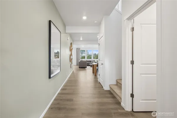 a view of a hallway with wooden floor and staircase