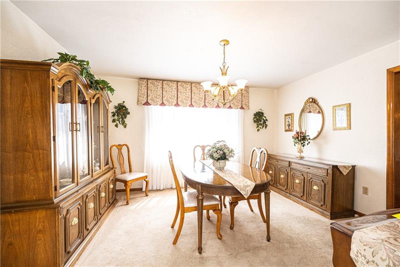 625 Main Street McKees Rocks, PA 15136 - Photo 4 of 25 DINING ROOM WITH HUGE WINDOW...OPEN TO KITCHEN AND LIVING ROOM.HARDWOOD FLOORS UNDERNEATH CARPETING