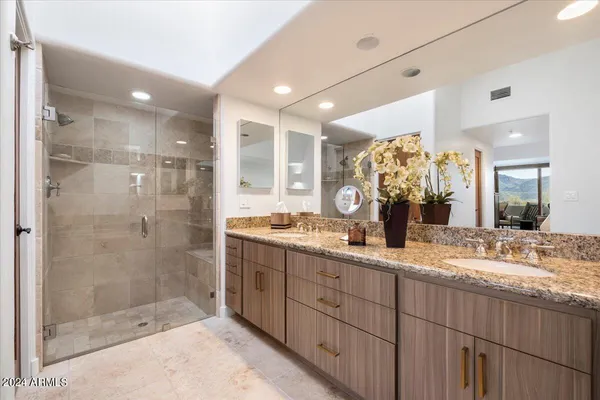 a bathroom with a granite countertop sink and a mirror