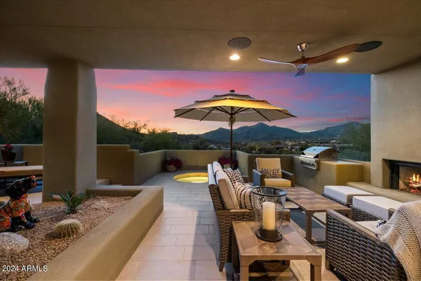 a outdoor living space with furniture and a fireplace