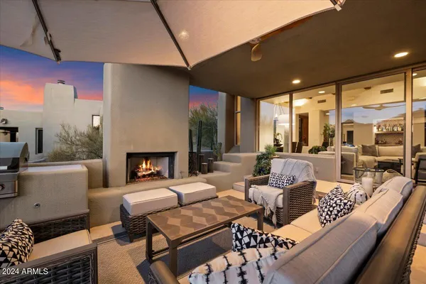 a living room with furniture a fireplace and a table