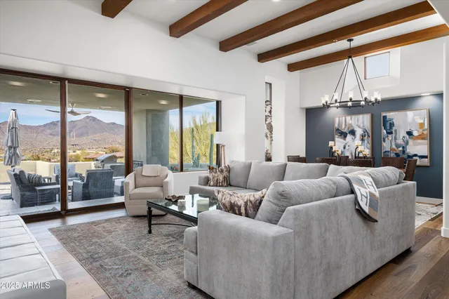 a view of a dining room with furniture and chandelier