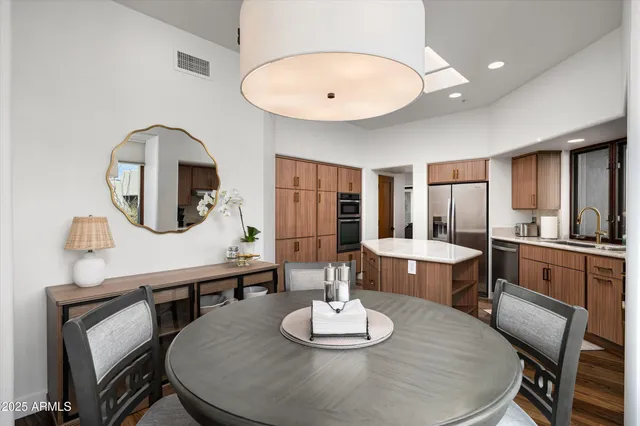 a bedroom with a bed chair and a large window