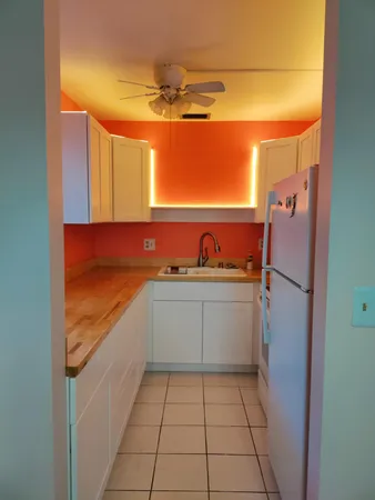 a kitchen with a sink and refrigerator