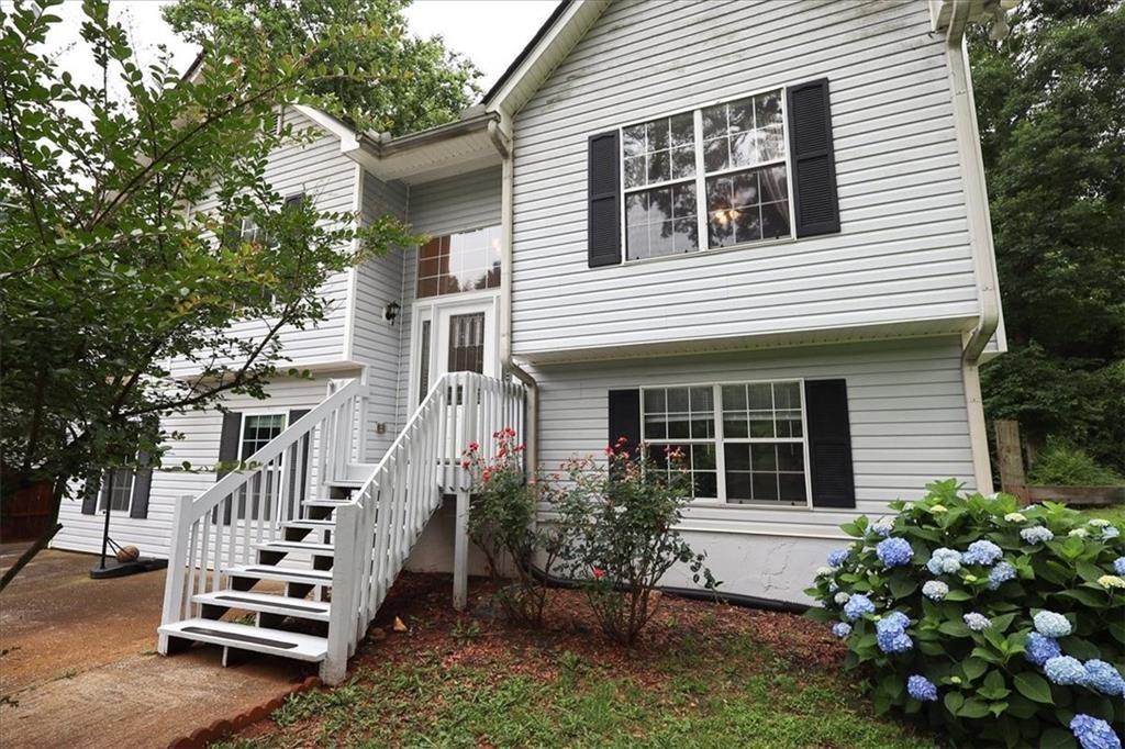 236 Hiram Sudie Road Dallas, GA 30157 - Photo 1 of 26 a front view of a house with a garden